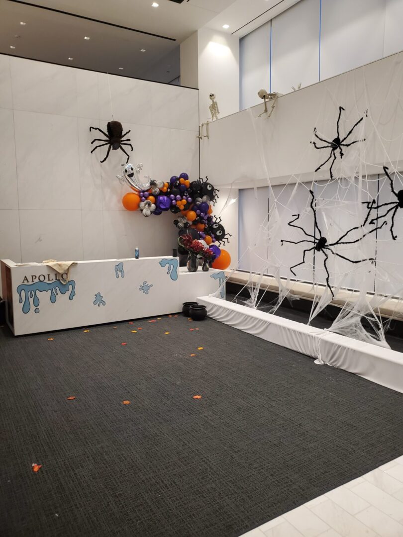 Halloween-themed office lobby with spider decorations.