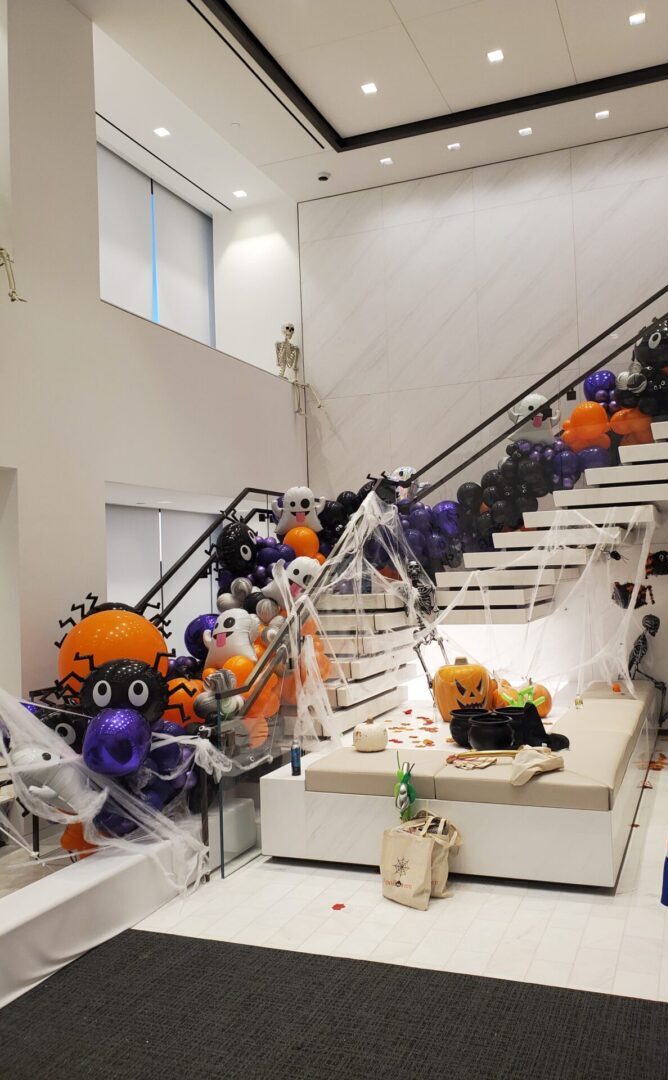 Halloween-themed staircase with balloons and decorations.