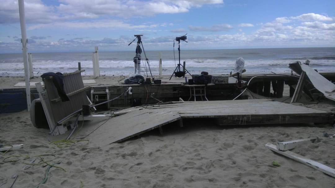 Damaged beach deck with camera equipment.