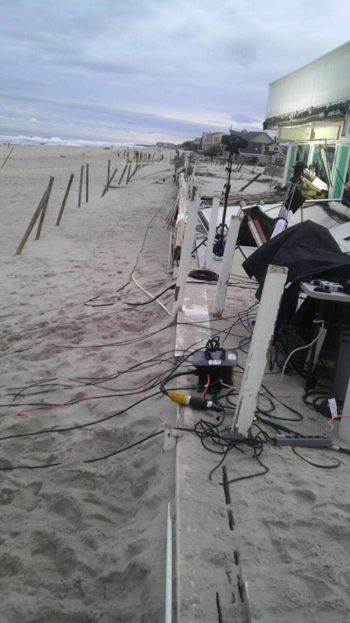 Beach with equipment and cables on sand.