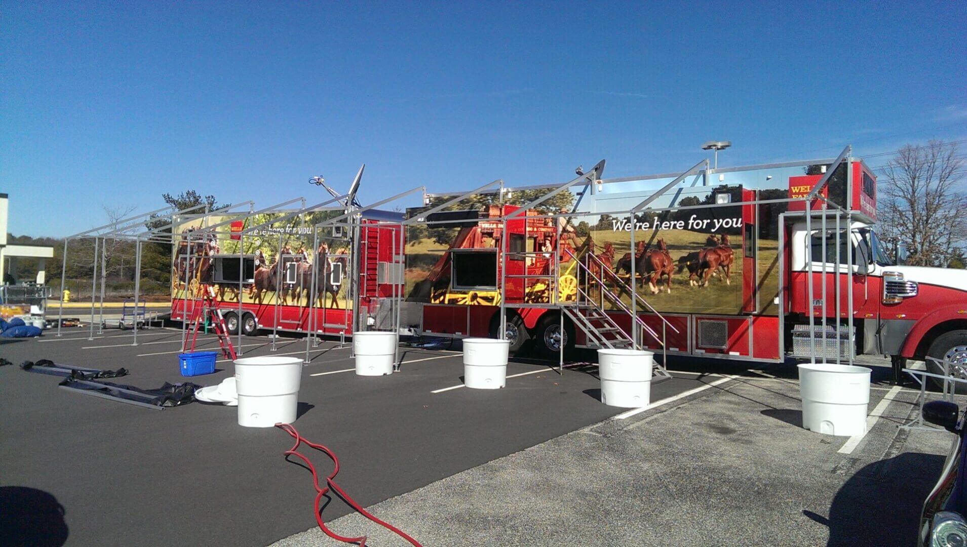 Colorful food trucks lined up outdoors with bright signage and outdoor seating arrangements.