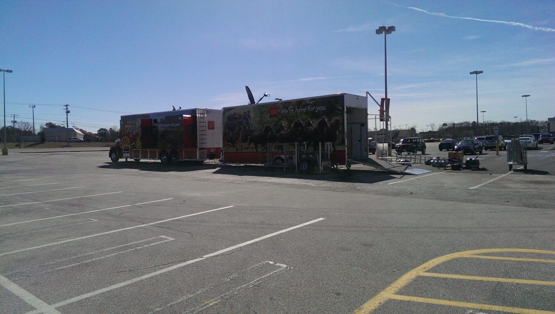 Empty parking lot outside a shopping plaza on a clear day.