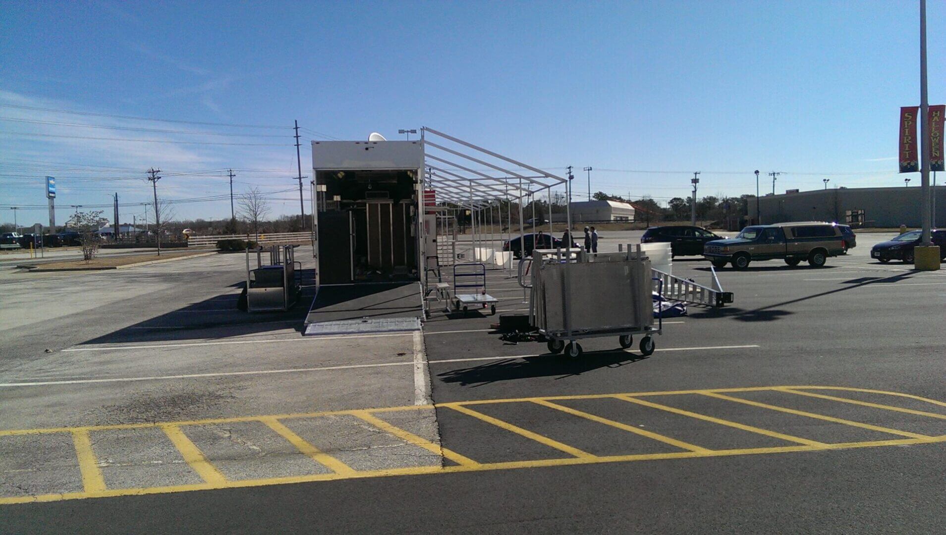 Airport ground crew preparing equipment near an aircraft gate.