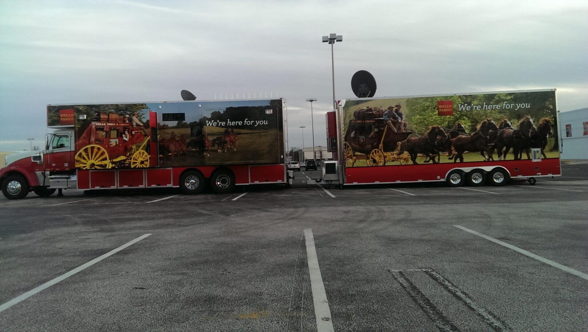 Two colorful trucks with historical battle-themed artwork parked side by side.